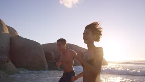 Diverse-Group-of-friends-swimming-in-the-sea-at-sunset