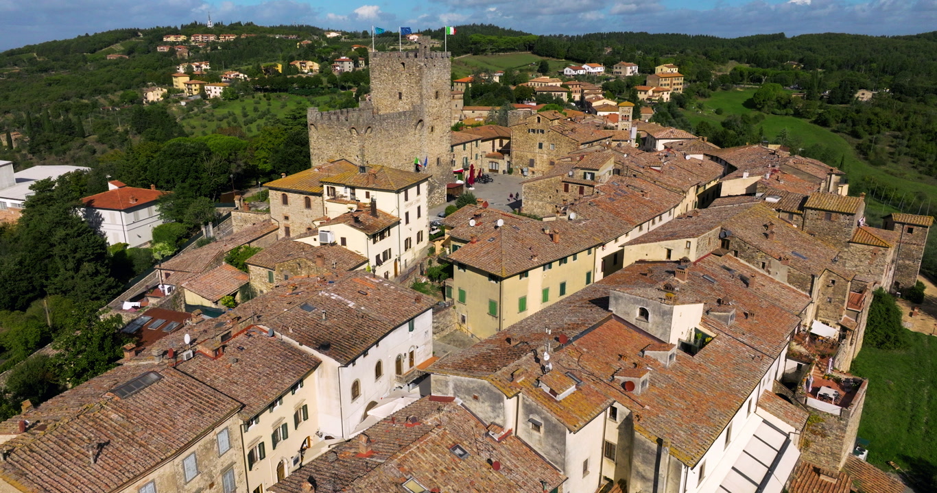 Rocca di Castellina, Chianti, Tuscany, Italy - A Medieval Fortress Rises Above the Historic Rooftops of the Hilltop Town - Aerial Drone Shot