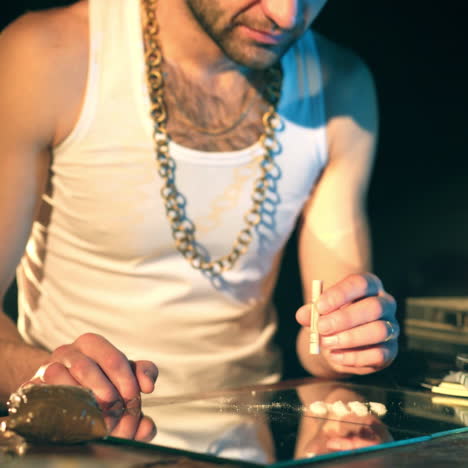 drug business. man holding a folded bill for sniffing and snorting the line.