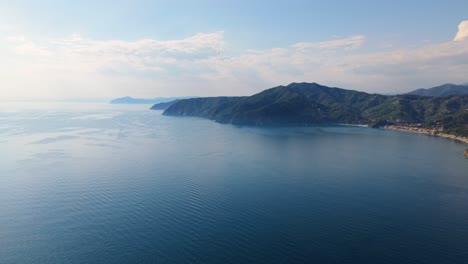 bright coastal view of italy with calm blue waters and scenic hills on a sunny day