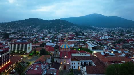 drone: dolly in shot of san francisco church at uruapan, michoacán at dusk