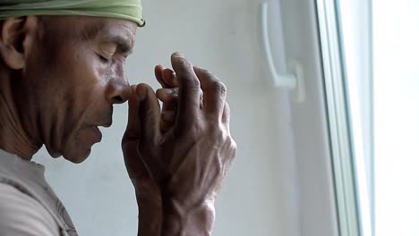 man-praying-to-god-with-hands-together-Caribbean-man-praying-with-background-with-people-stock-video-stock-footage