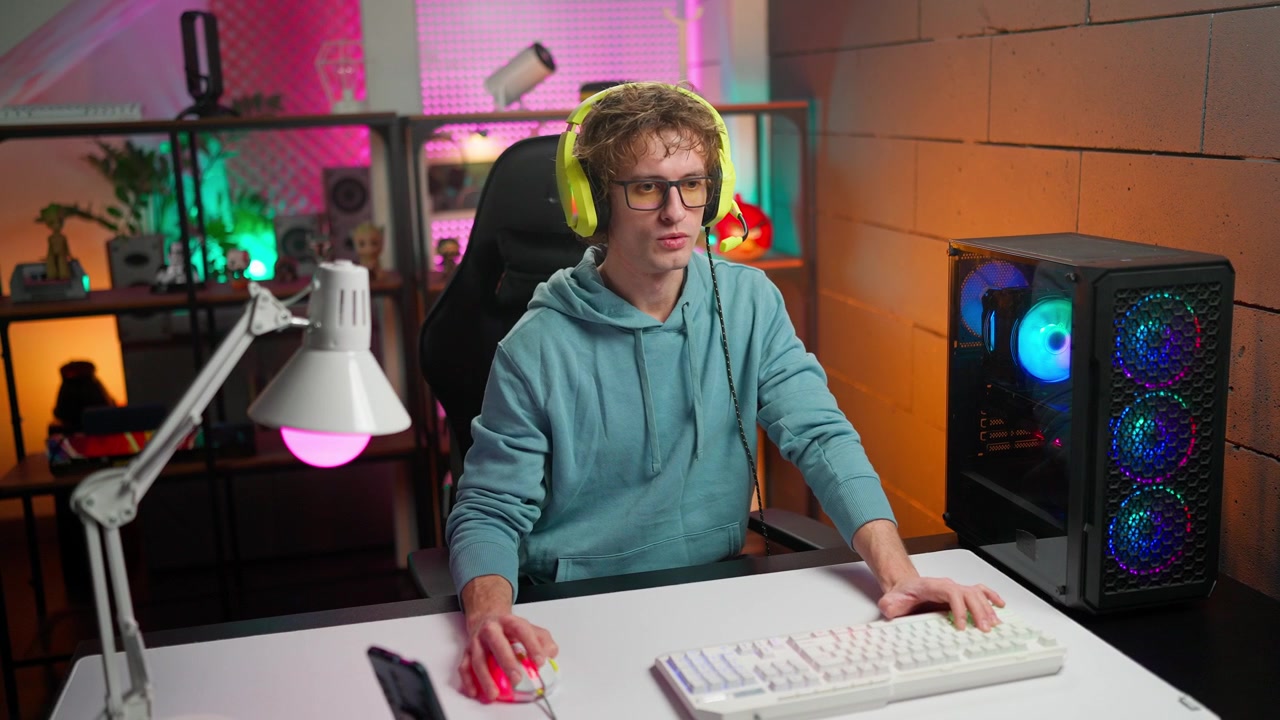 Young Man Playing Video Games on a Gaming PC