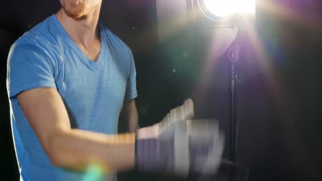male photographer adjusting flashlight during shoot
