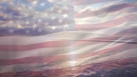 Digital-composition-of-waving-us-flag-against-aerial-view-of-the-beach-and-sea-waves