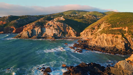 coastal hills ocean swell at summer drone view. turquoise waves washing stones