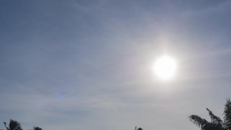 timelapse b-roll footage of midday sun. star shape sunbeam flare sunbeam in the day sky, sunlight shine in blue sky and fluffy clouds. beautiful rays shine through white clouds. skyscape background