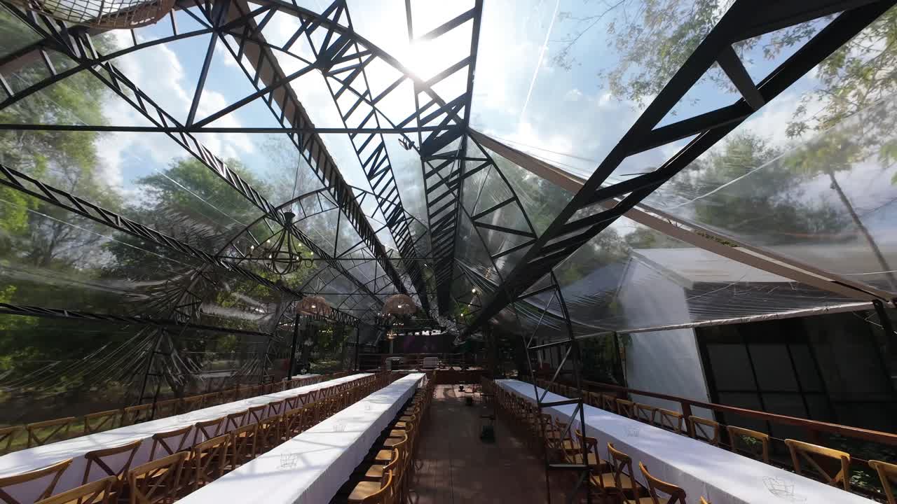 Dynamic FPV drone fly at decorated wedding place crossing tropical forest in Argentina