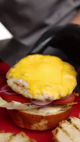 chef preparing a delicious cheeseburger