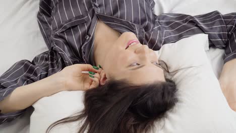 top view of charming girl just woke up and lying on the bed and dreaming,slider