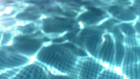 ripples on the surface of the transparent blue water in a pool