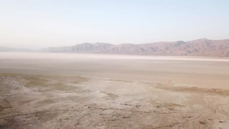 abandoned salt lake dry climate drought nobody live in desert rainfed agriculture flora species and water supplement side lake rural countryside in summer season hazy day local people poverty in iran