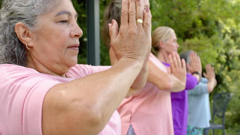 Senior-biracial-woman-practices-yoga-outdoors