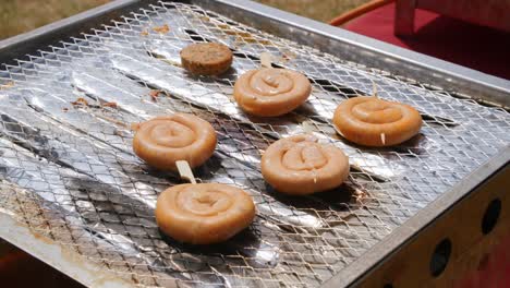 sausage being cooked on top of a barbecue