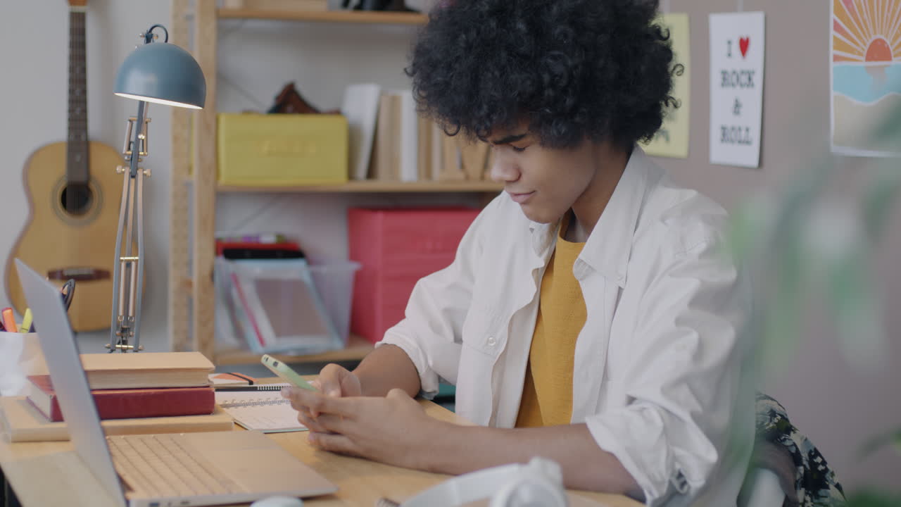 Teenager Studying at Desk