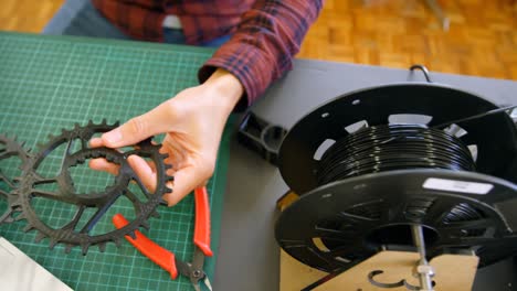 mechanic checking chain rings in workshop 4k