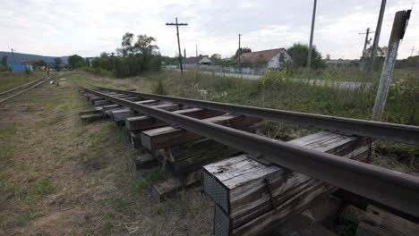 a new section of railroad track being built. steel rails on stacked wooden sleepers showcase a transport infrastructure project, symbolizing progress and development in the countryside