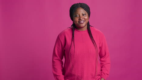 woman in pink sweater posing for picture