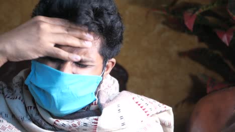 man experiencing headache while wearing a mask