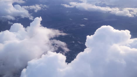 big fluffy clouds from an airplane window with clouds during travel on a flight