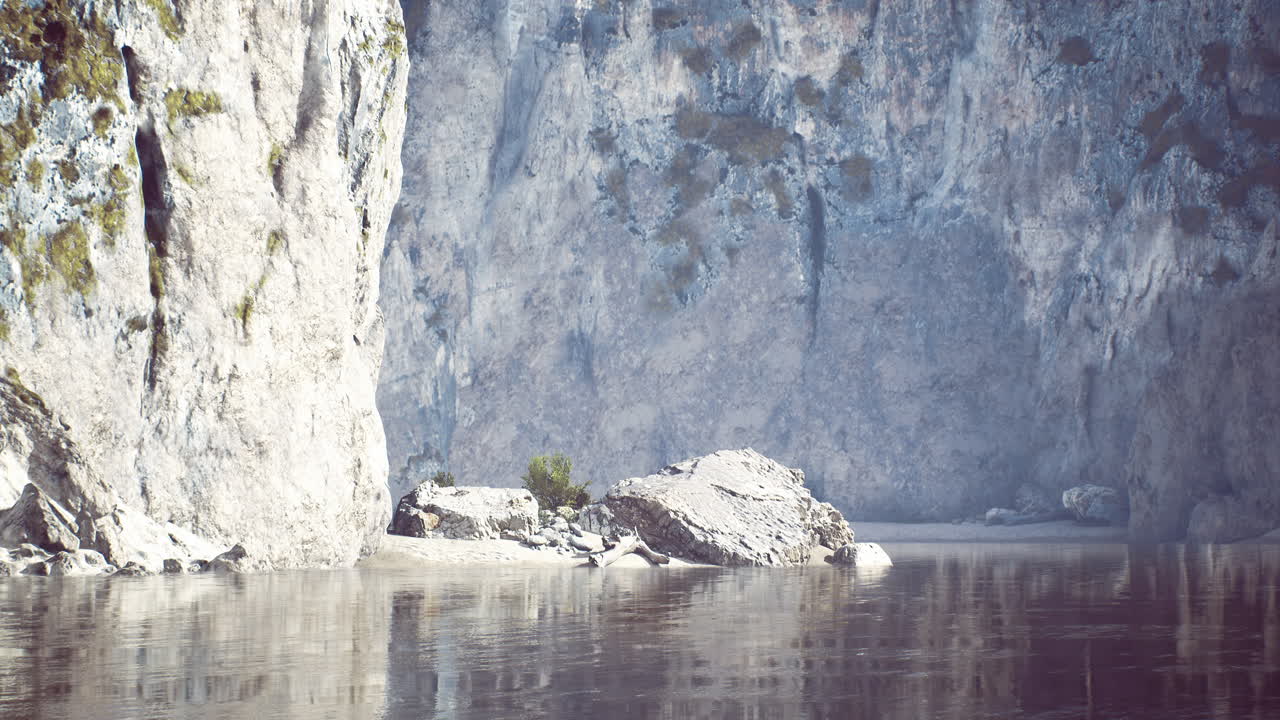 Rocky cliffs mirror in calm water at a serene riverside location