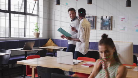 animation of data processing and stock market over diverse business people talking in office
