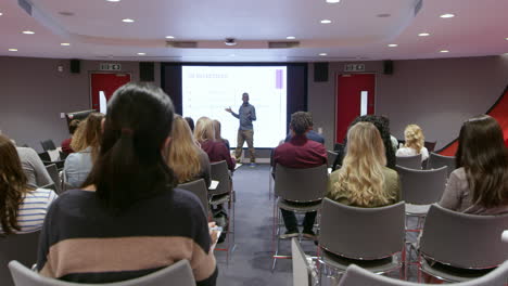 teacher using an av screen in a university classroom, shot on r3d