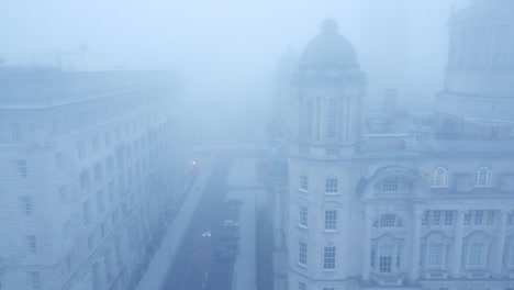 ghostly dense city fog aerial view down chilling downtown cityscape streets dolly left