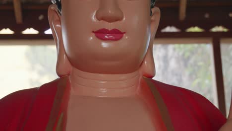 red buddha statue with red swastika symbol showing cultural differences