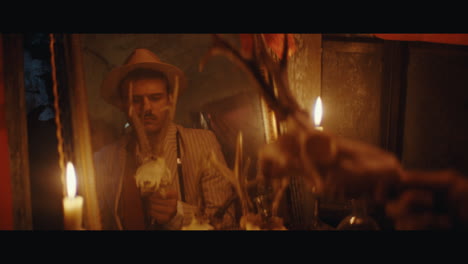 a man in hat looks into mirror in the gypsy circus cart