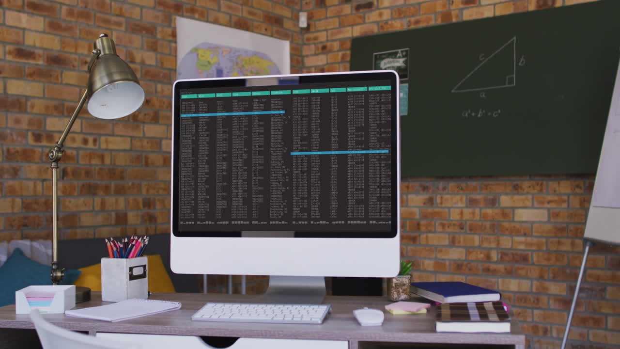 Computer screen with data processing standing on desk in office
