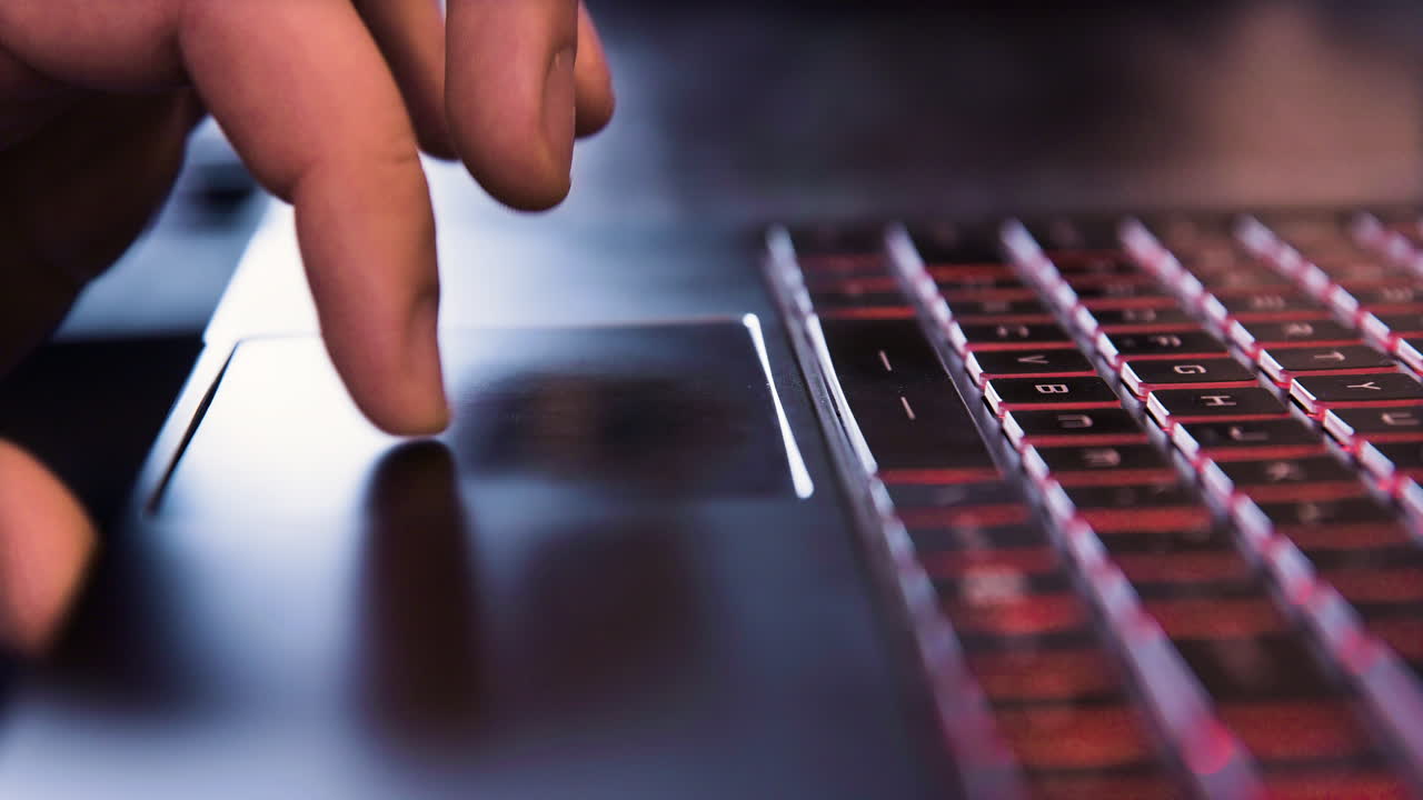 Man Using Touchpad on Laptop Computer