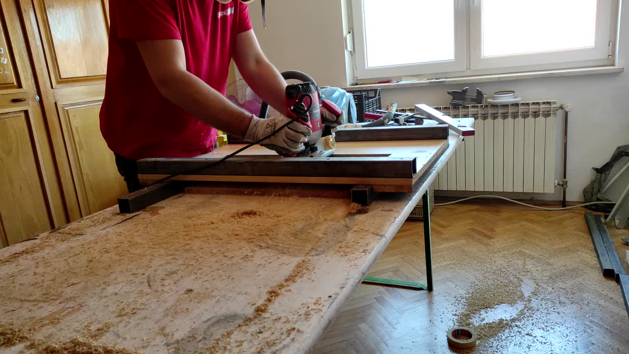 Woodworker work with milling router machine to flatten the hard wood