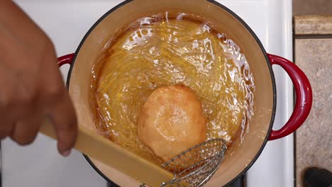 top down view of frying indian bhatura bread dough in hot oil - chana masala series