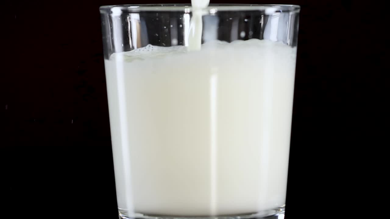 A sequence showing milk being poured into a glass, filling it gradually.