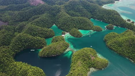 Picturesque-Nature-of-Philippines,-Aerial-View-of-Sugba-Lagoon-and-Green-Hills-Above-Tropical-Sea,-Siargao-Island,-Drone-Shot