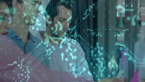 coworkers standing in modern office, reviewing holographic circuit overlay with glowing nodes