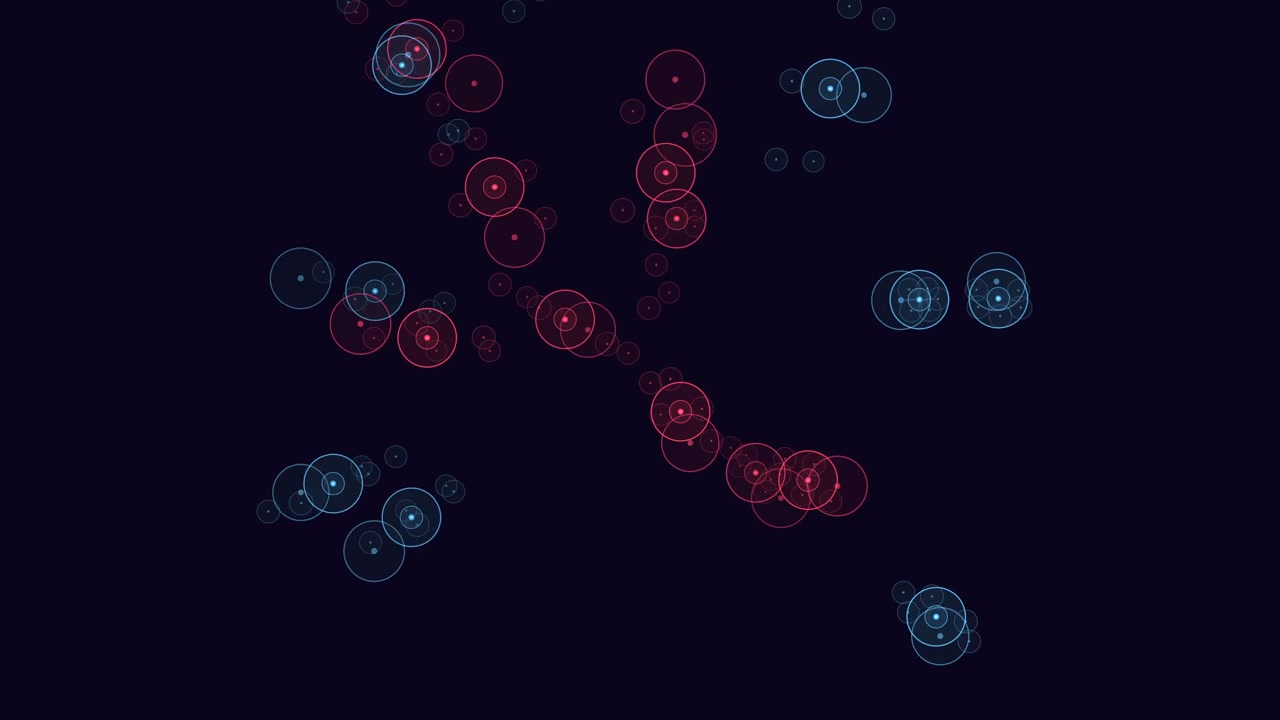 A circles in varying sizes and colors forming a spiral pattern against black background. Sizes range from small at center to large at periphery in shades of blue, red, and green