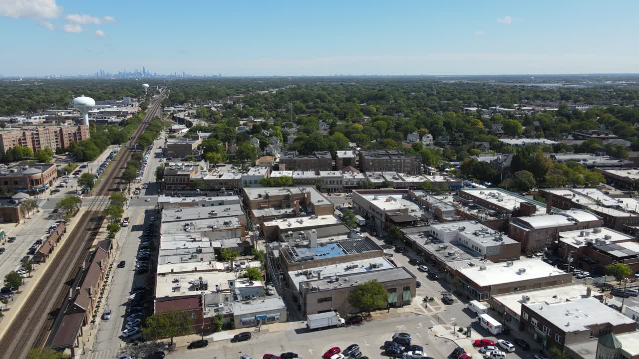 La Grange, IL on a sunny fall day, showcasing streets, buildings, and the suburban landscape With Downtown Chicago in Background. Crane Down Left Day E