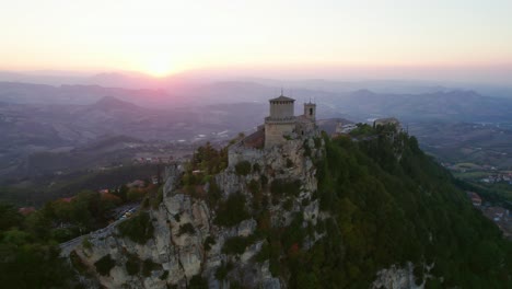 three towers of san marino, italy, drone orbit view during sunset