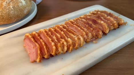 picking up with a fork crispy crunchy pork crackling, tasty pork belly, 4k shot