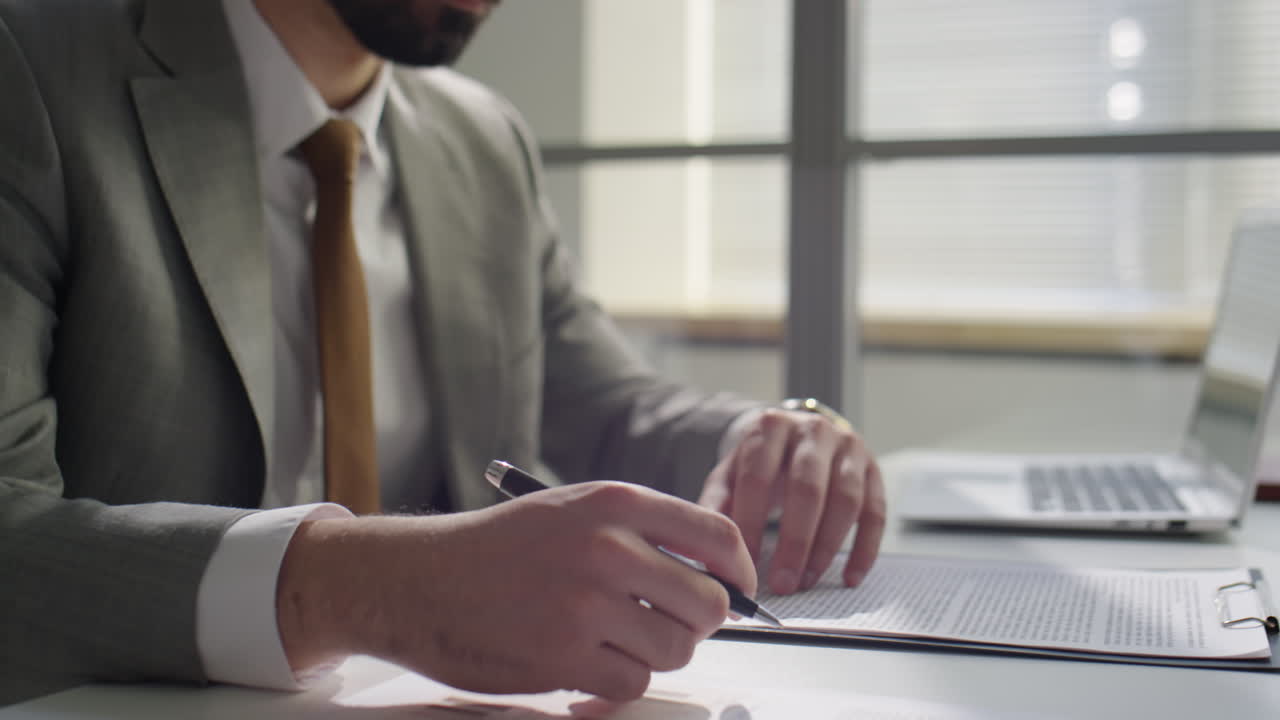 Businessman Signing Contract and Giving Handshake to Partner