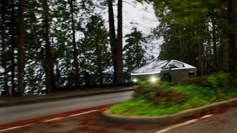 tesla cybertruck driving through forest