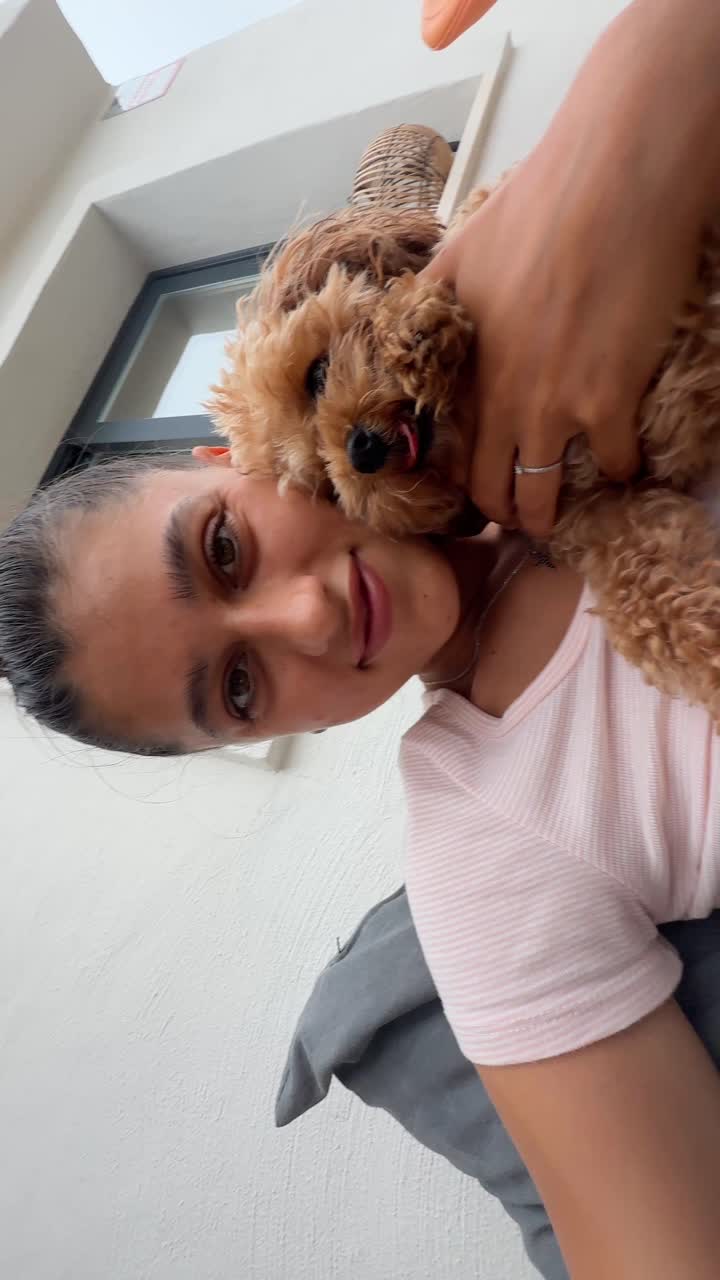 Woman cuddling a dog on a patio