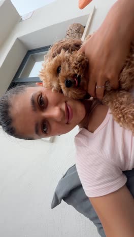 woman cuddling a dog on a patio