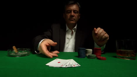 Gambler-throwing-down-his-poker-full-house