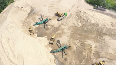 Aerial-view-loading-bulldozer-in-open-air-quarry