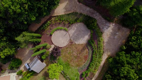 villa garden with walking path in southern france, aerial top view rising shot