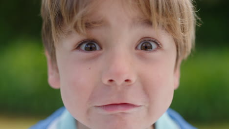 portrait cute little boy making faces having fun happy kid enjoying making silly expressions in sunny park 4k