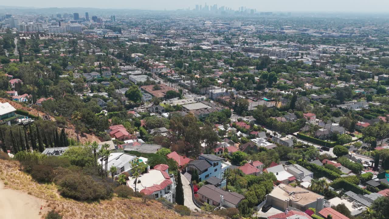 Aerial descending and tilting up shot of the Los Angeles basin as seen from Hollywood Hills, California. 4K